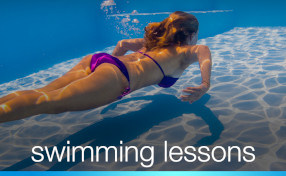 Go to swimming lessons page - woman swimming underwater